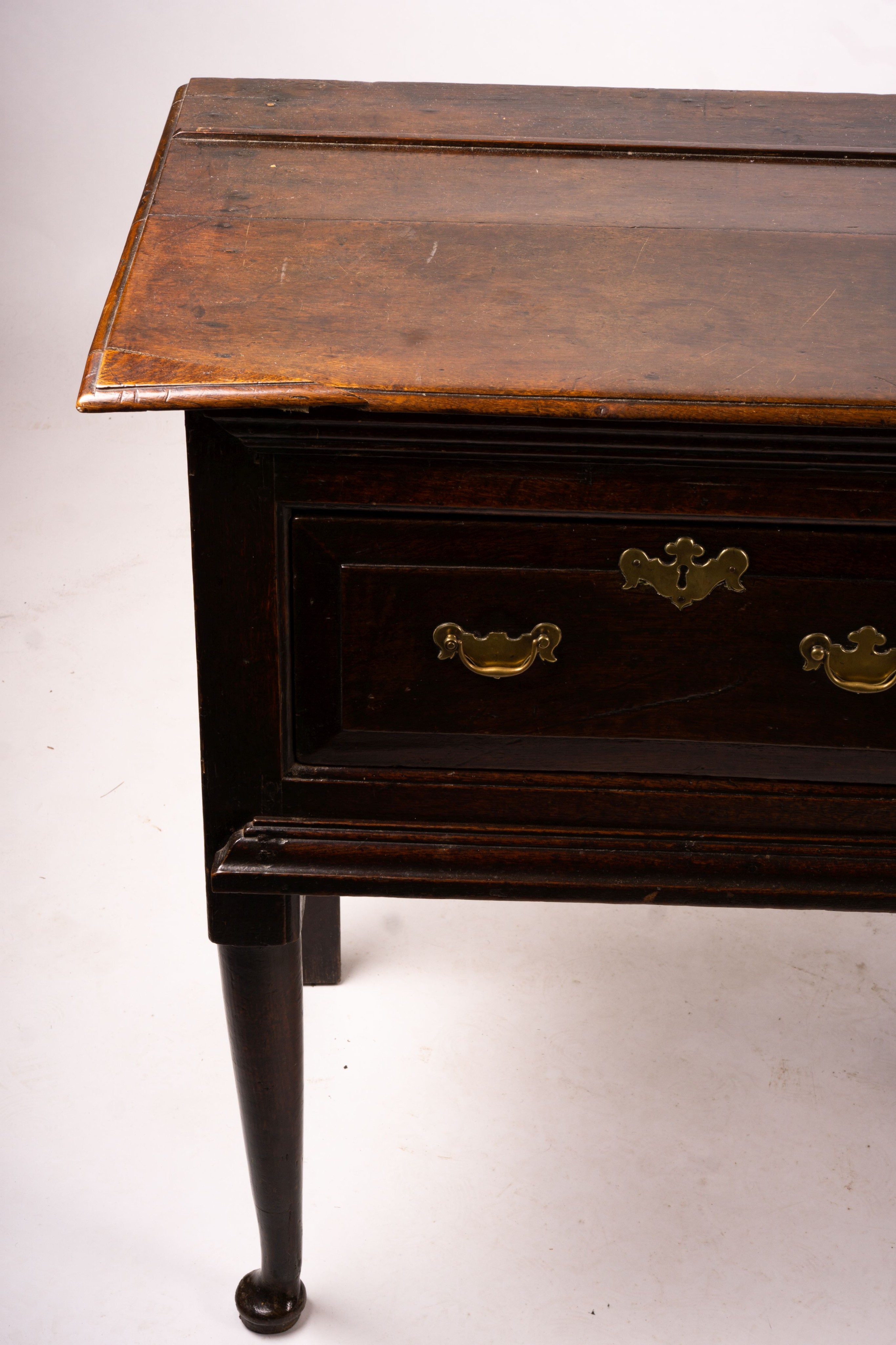 An 18th century oak low dresser on pole turned legs and pad feet, length 198cm, depth 53cm, height 88cm